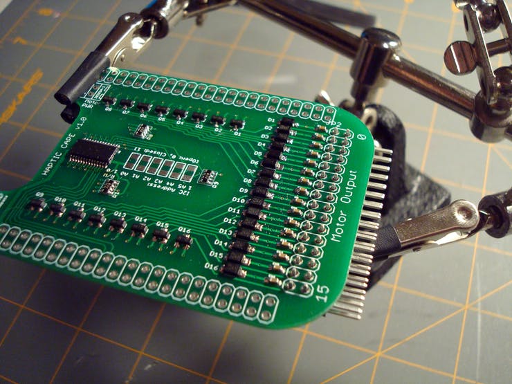 When I need to solder in large headers, I find it useful to have a Third Hand hold the pieces in place. Some find this more fiddly than just resting the board on the work surface but I like having insurance that nothing will slide during soldering.