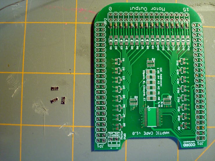 Now repeat the process for the 4-circuit 10.0 kΩ resistor networks. Tin one out of the eight pads and, after remelting the solder, slide the resistor network into place.