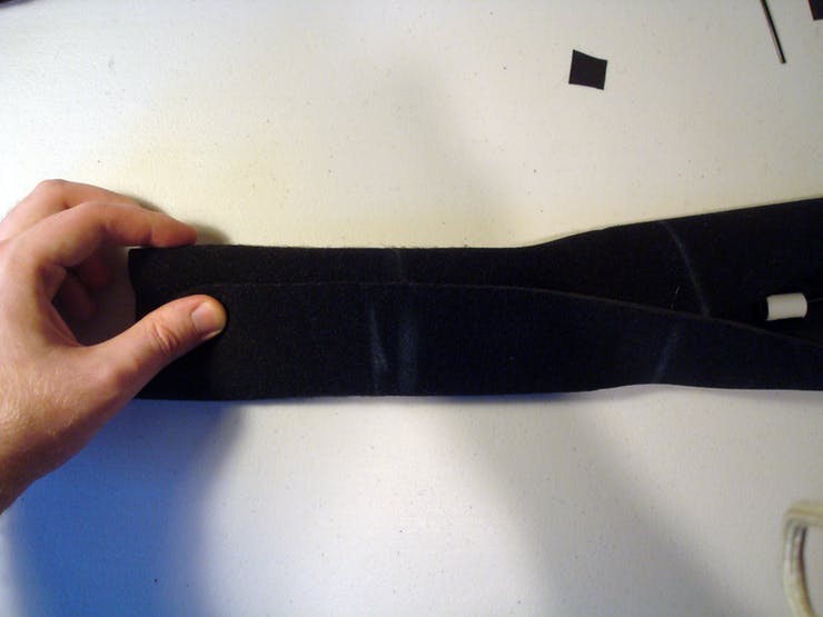 Take the other edge with the velcro and fold it over the other folded edge kinda like a burrito. This protective tube of fabric will completely surround the tactor assemblies and provide the wearer with two layers of material between them and the potentially irritating hardware within. 