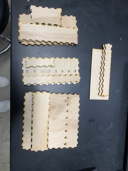 Figure 3. Grouped Snap-Fit Pieces. Bottom Step Box (right & middle), Top Full Box (left), and Extra Pieces (top).